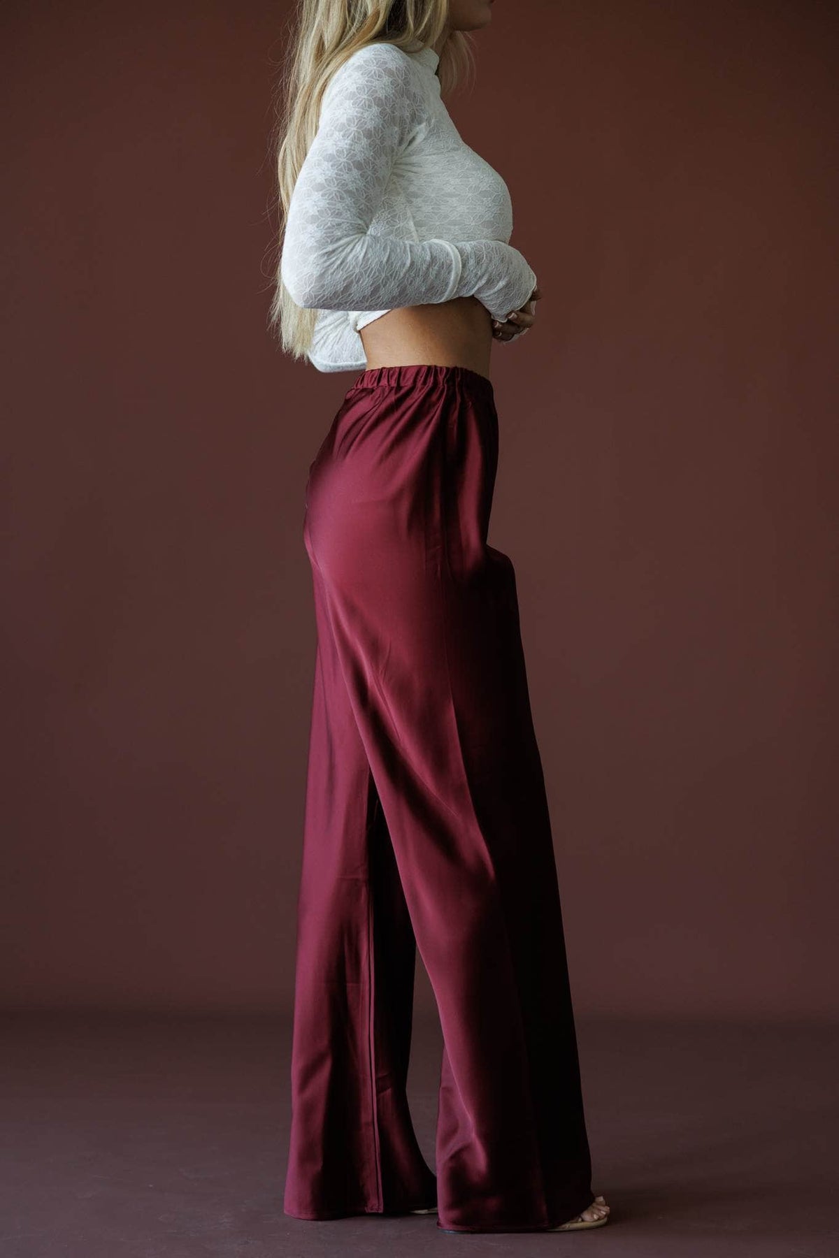 Satin State Pants in mulberry, side view showing the flowing satin wide leg