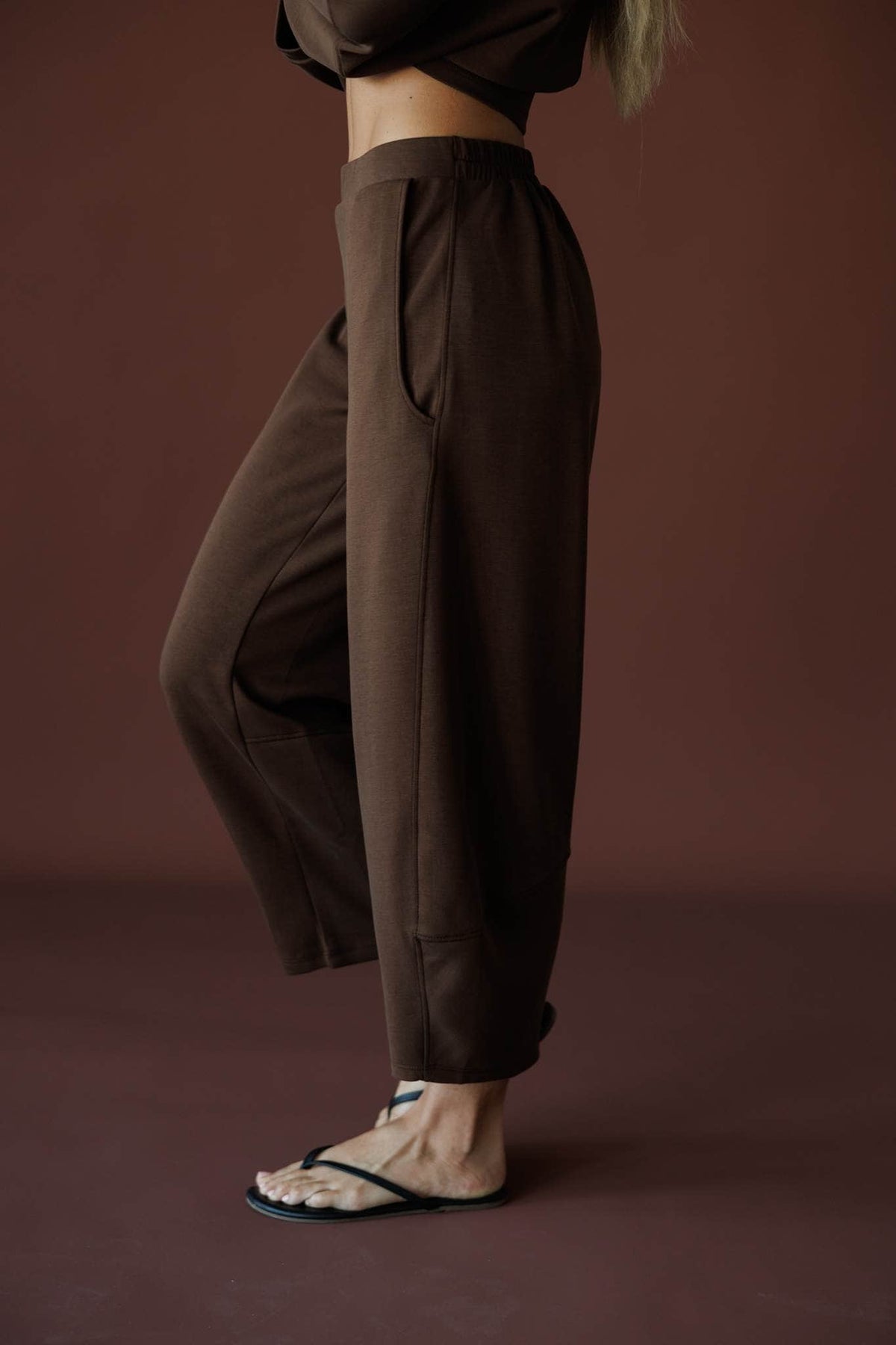 Scuba Barrel Sweatpants in brown, side view close-up worn with sandals