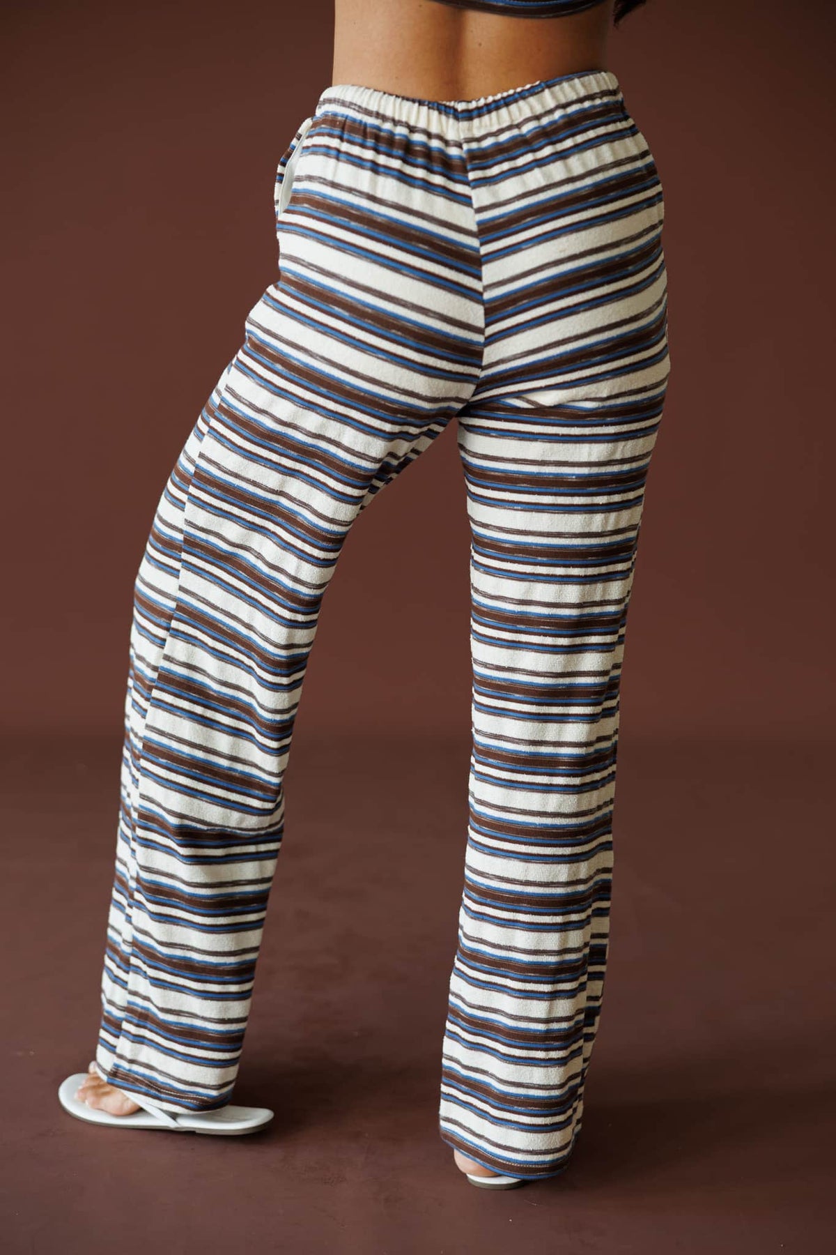 Slow Mornings Pant in blue brown stripe, side view showing the striped flared leg