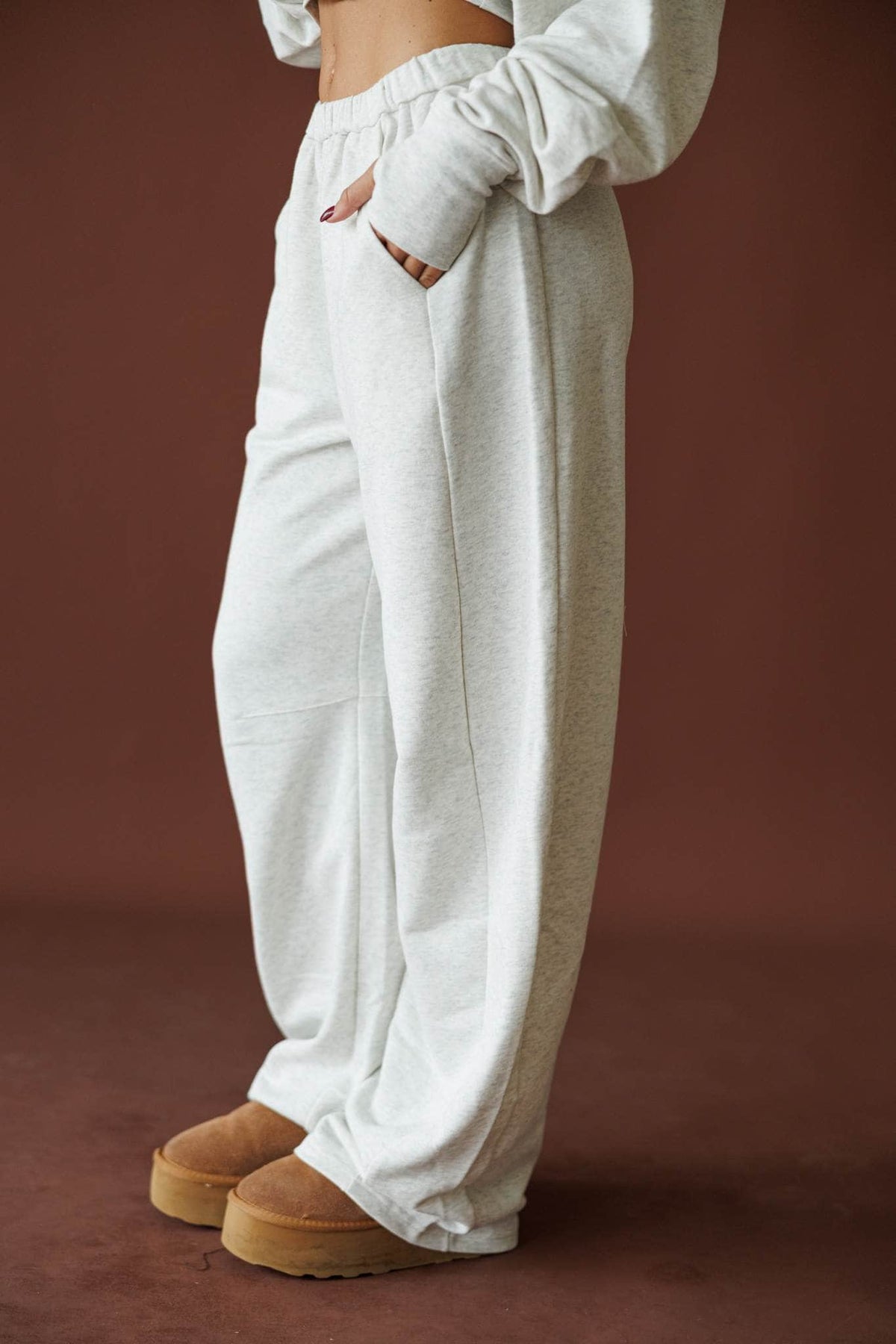 Slow Sunday Terry Pants in heather grey, side view on model with a hand in the pocket