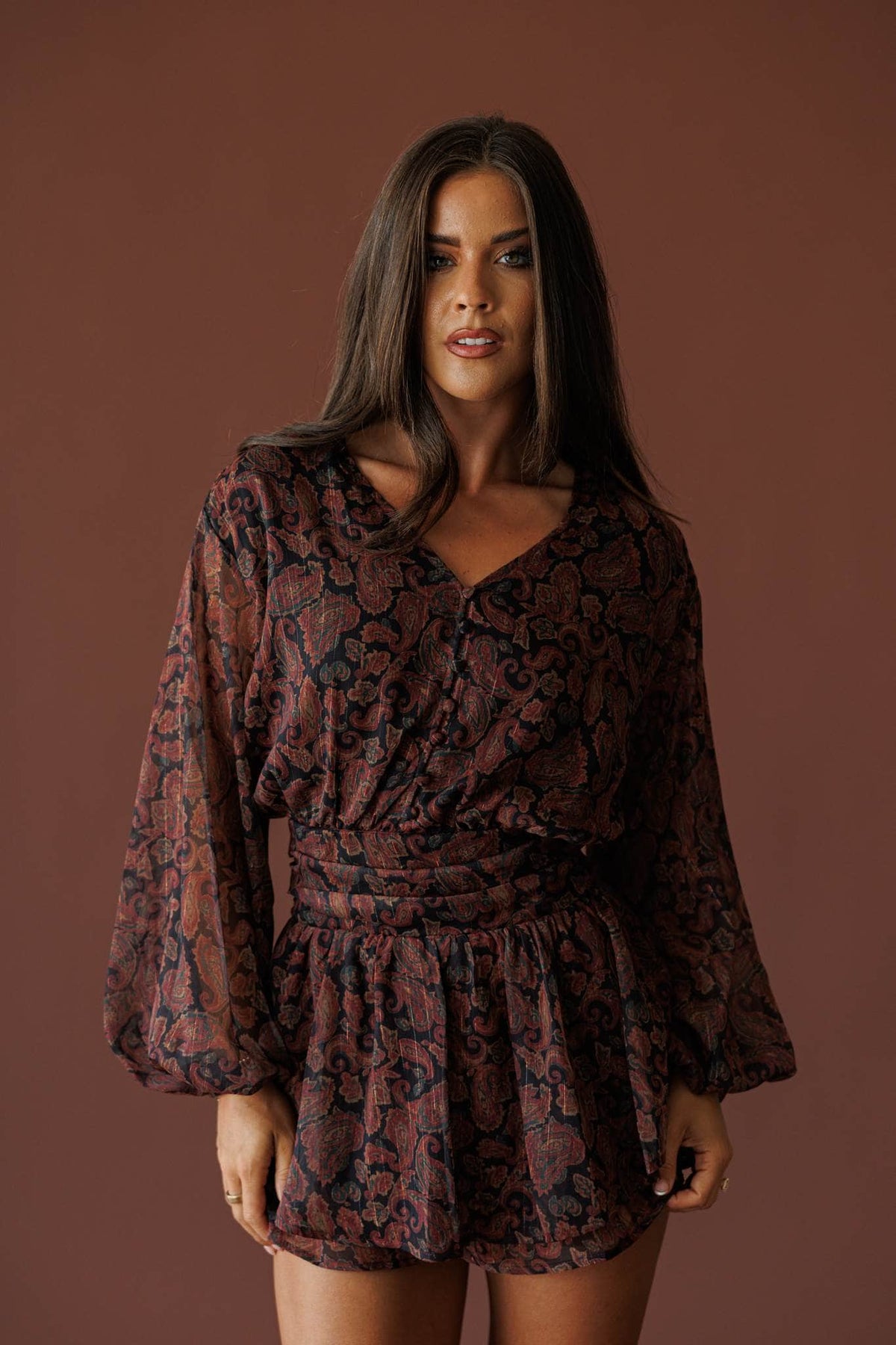 Sonora Paisley Romper in black, full-length view on model looking to the side