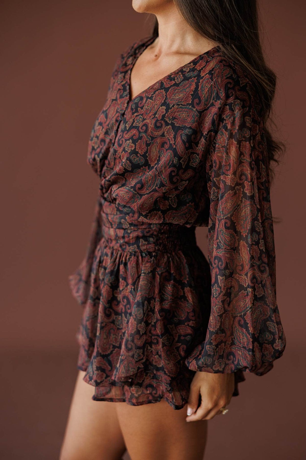 Sonora Paisley Romper in black, side view showing the balloon sleeve and flared short