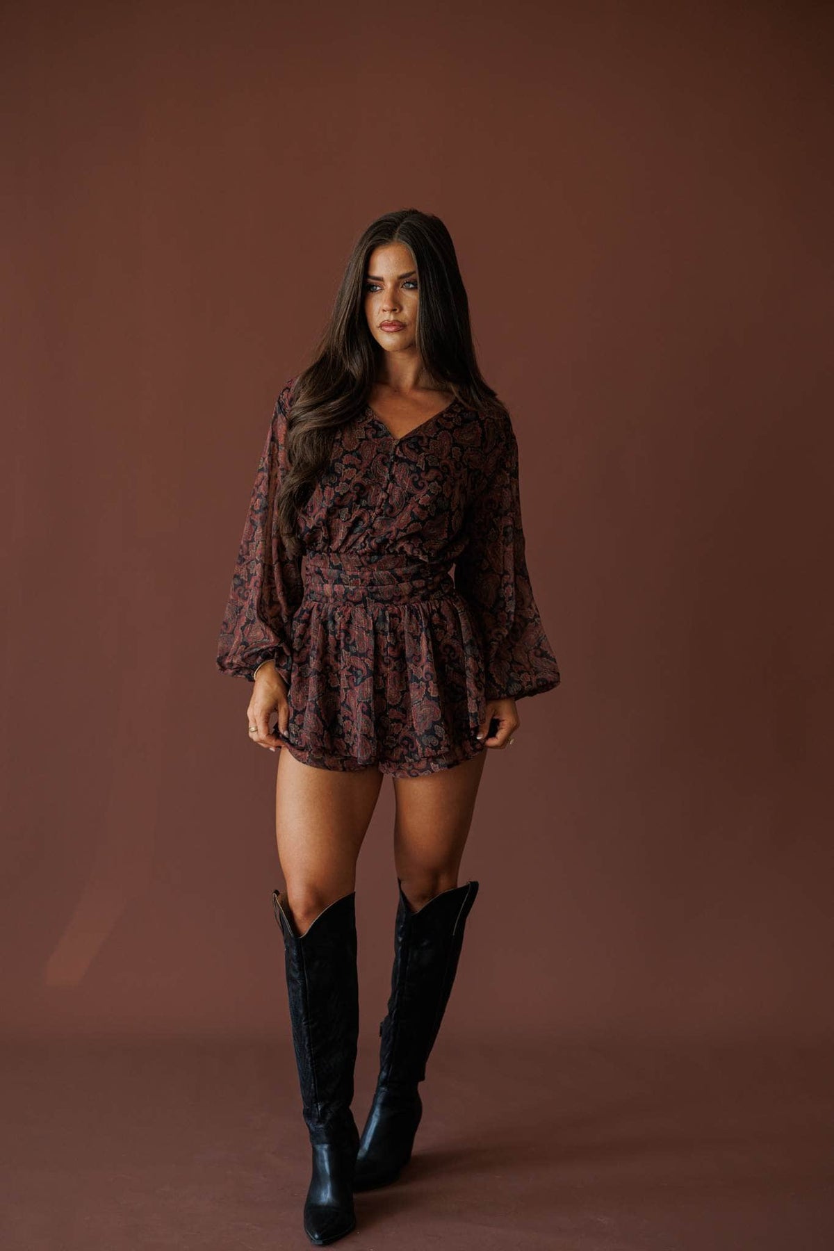Sonora Paisley Romper in black, full-length view on model with tall black boots