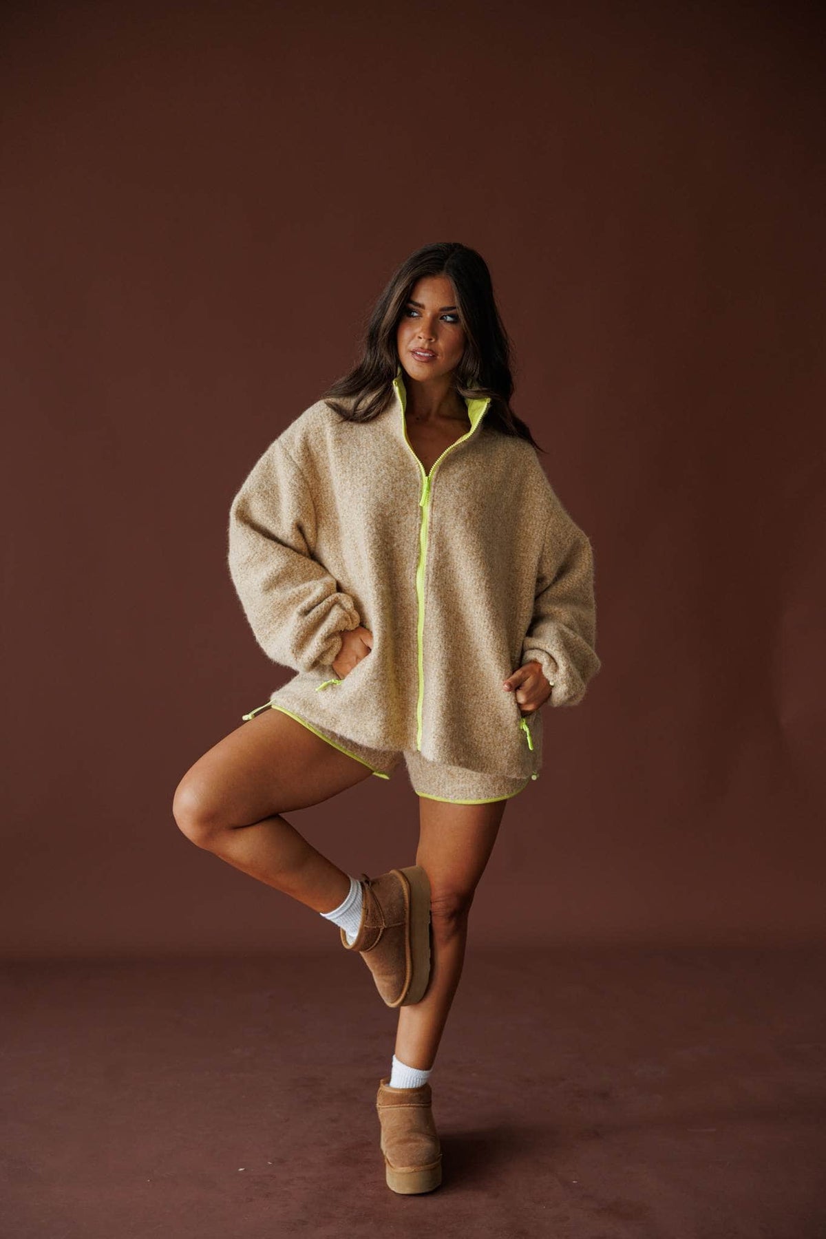 Sundance Sherpa Shorts in butter, full-length view on model with one knee raised