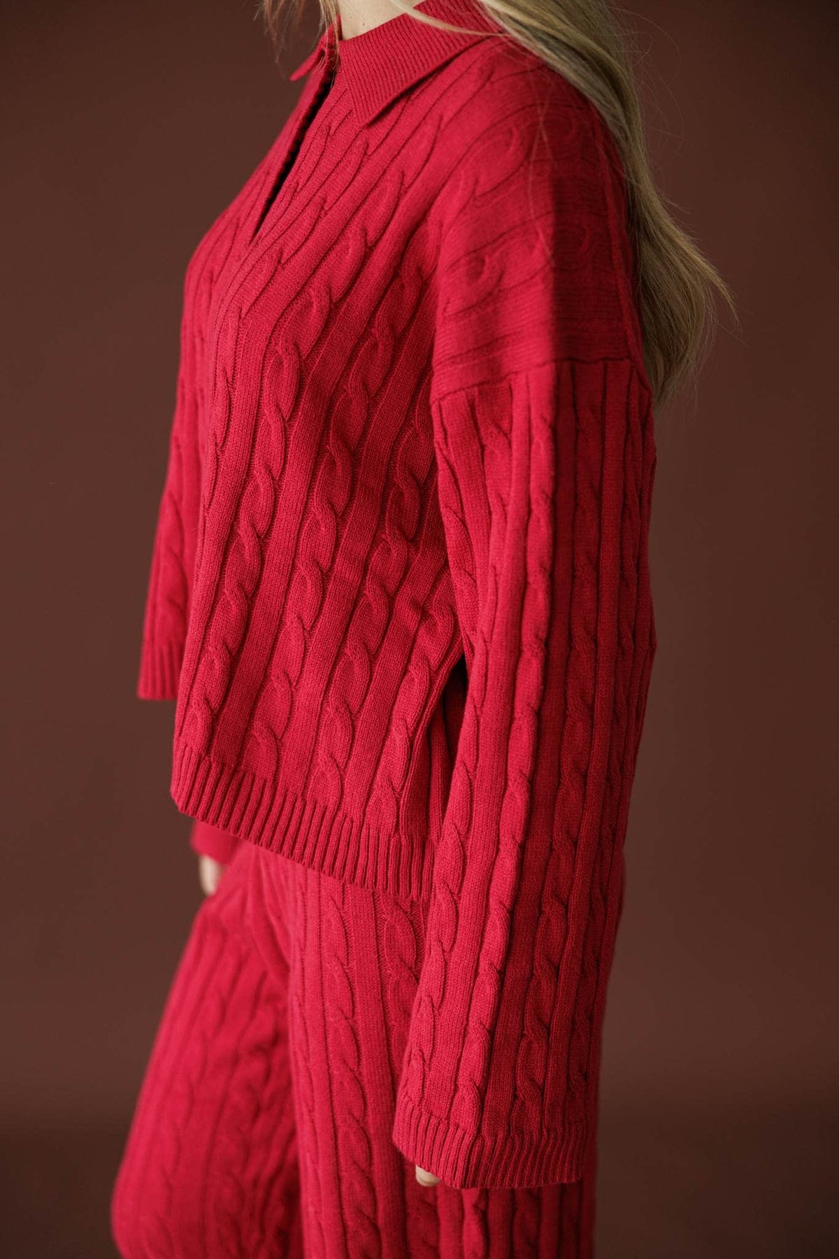 Cherry Cable Knit Sweater in red, side view showing the oversized cable knit