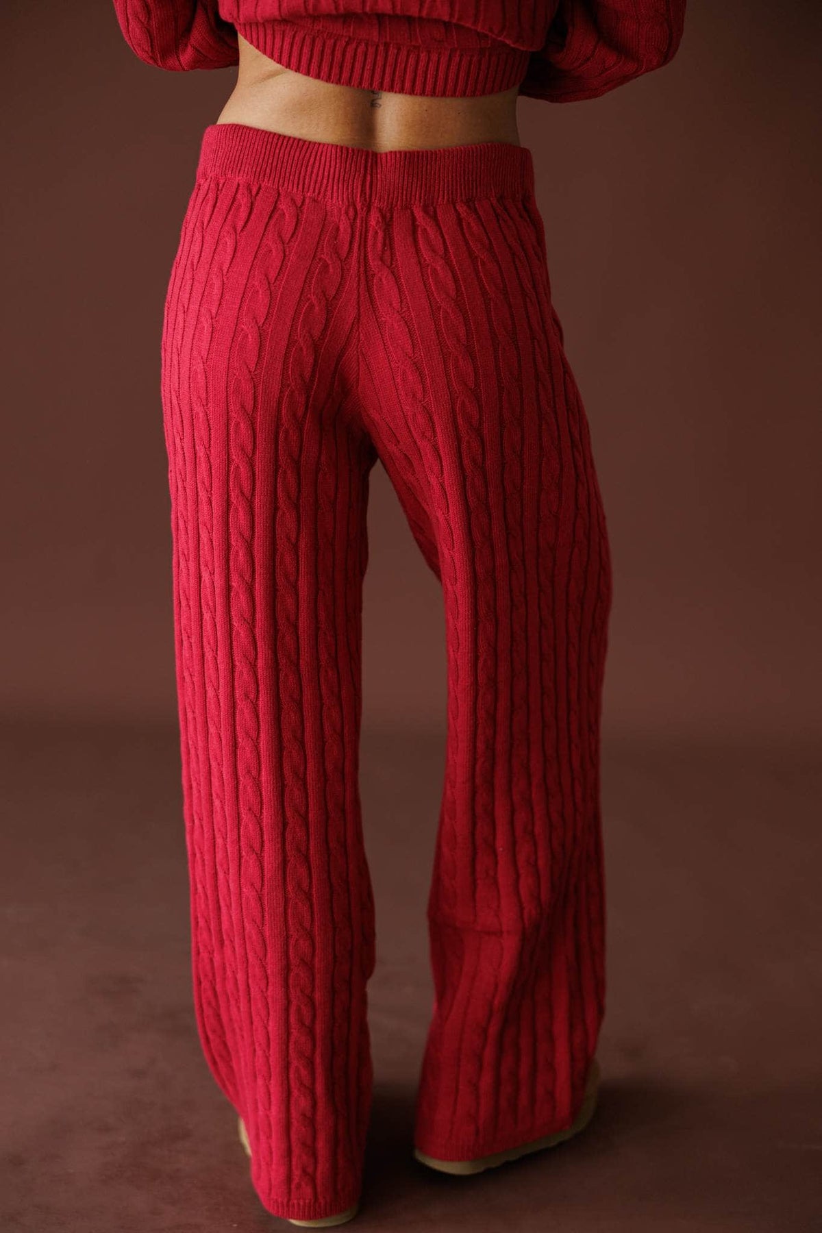 Cherry Cable Knit Pants in red, back view showing the wide leg cable knit pants