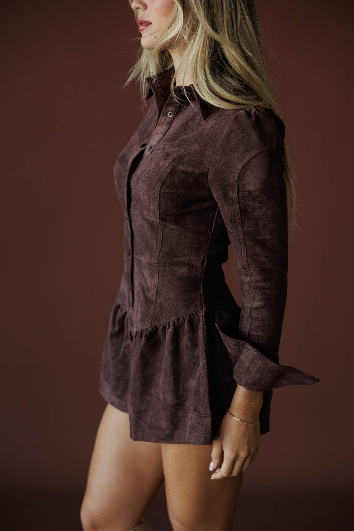 The Outrider Romper in chocolate, side view showing the ruffled peplum shorts