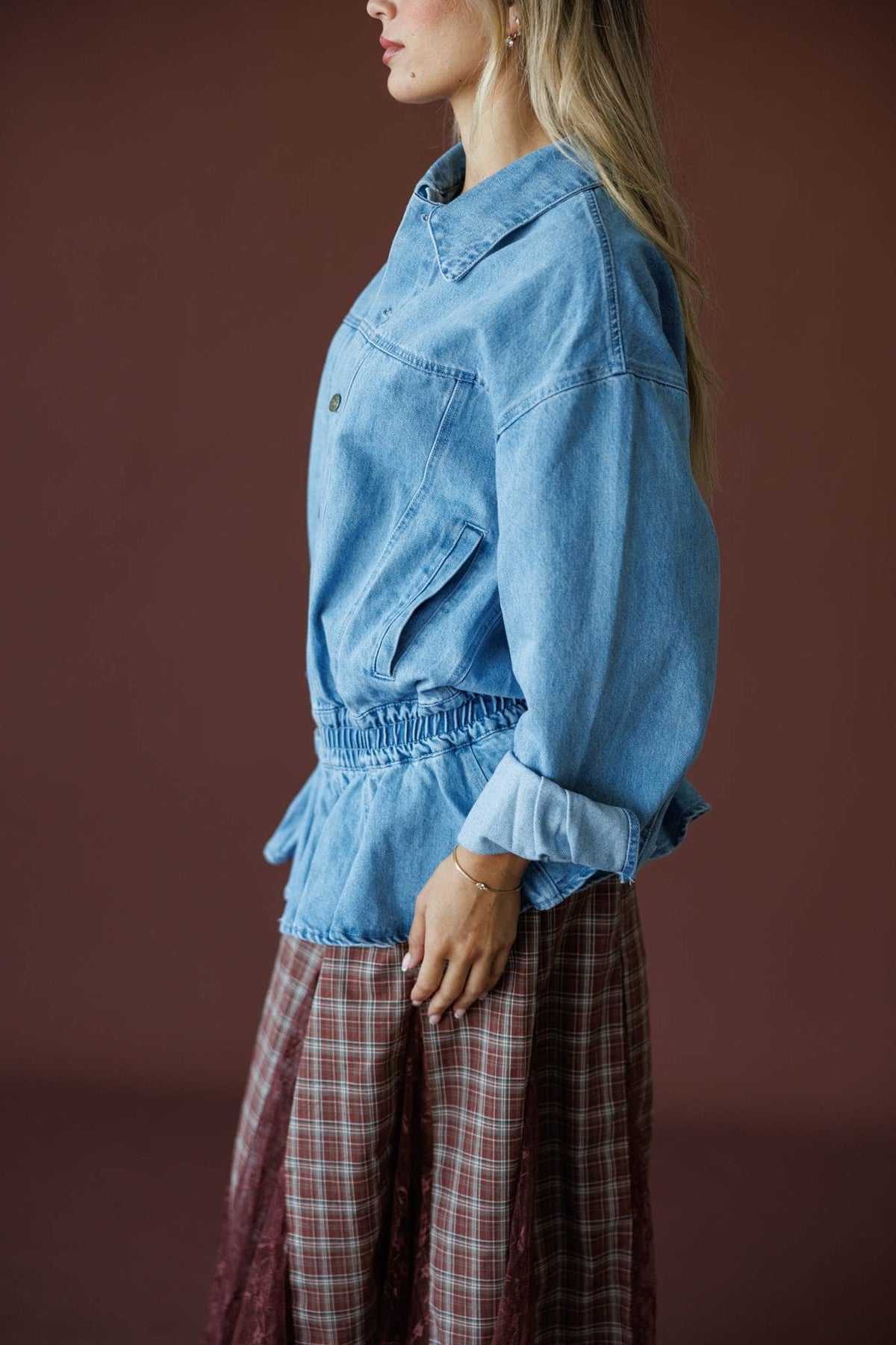 The Remix Denim Jacket in denim blue, side view showing the collar and cuffed sleeve