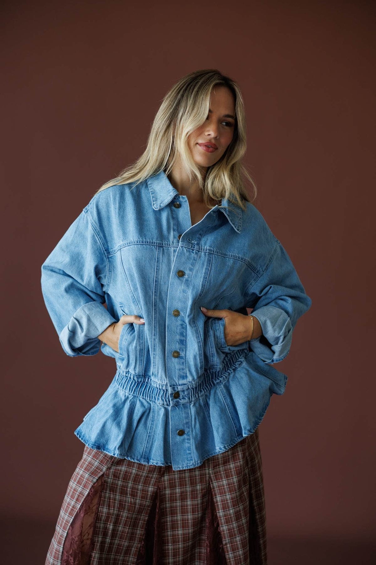 The Remix Denim Jacket in denim blue, full-length view with a plaid maxi skirt