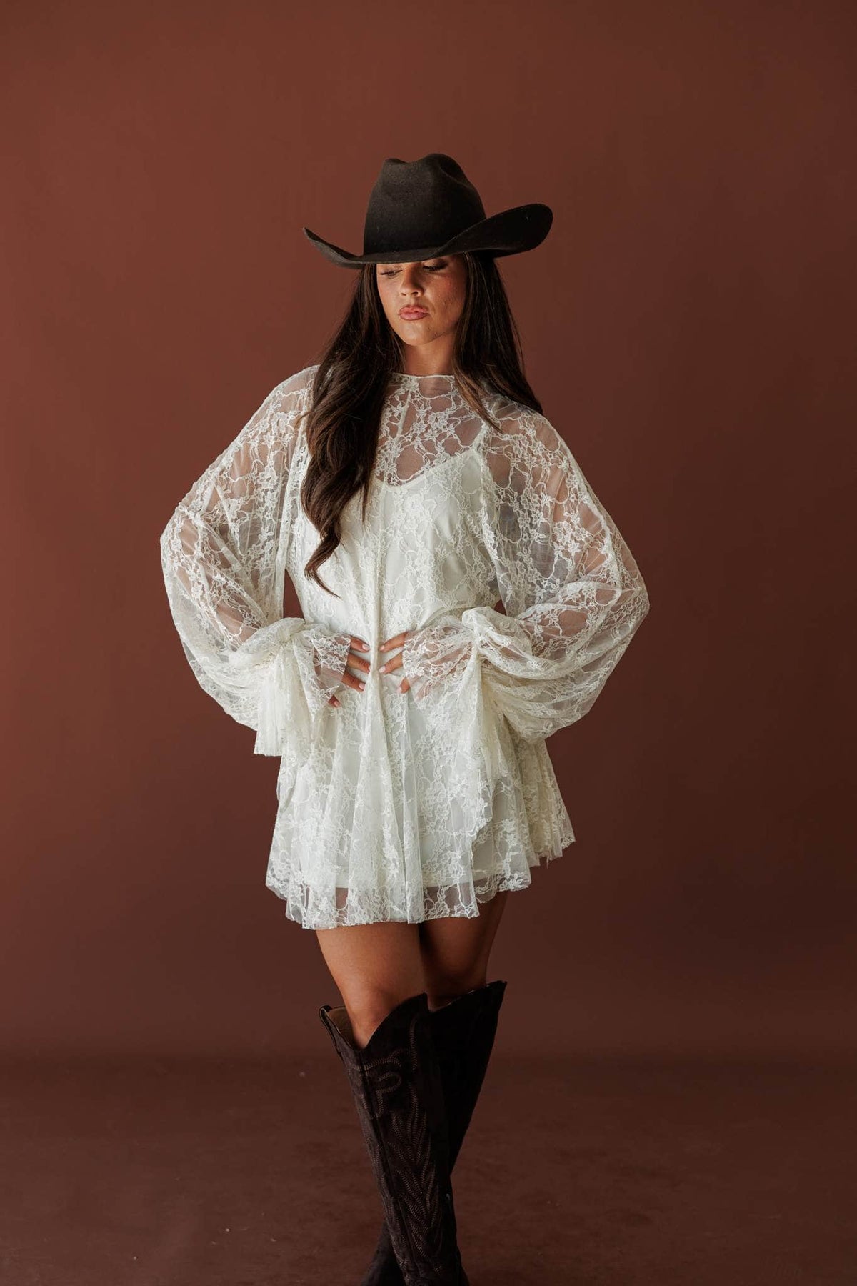 Lace Legend Mini Dress, in cream, full-length view with a black hat and boots