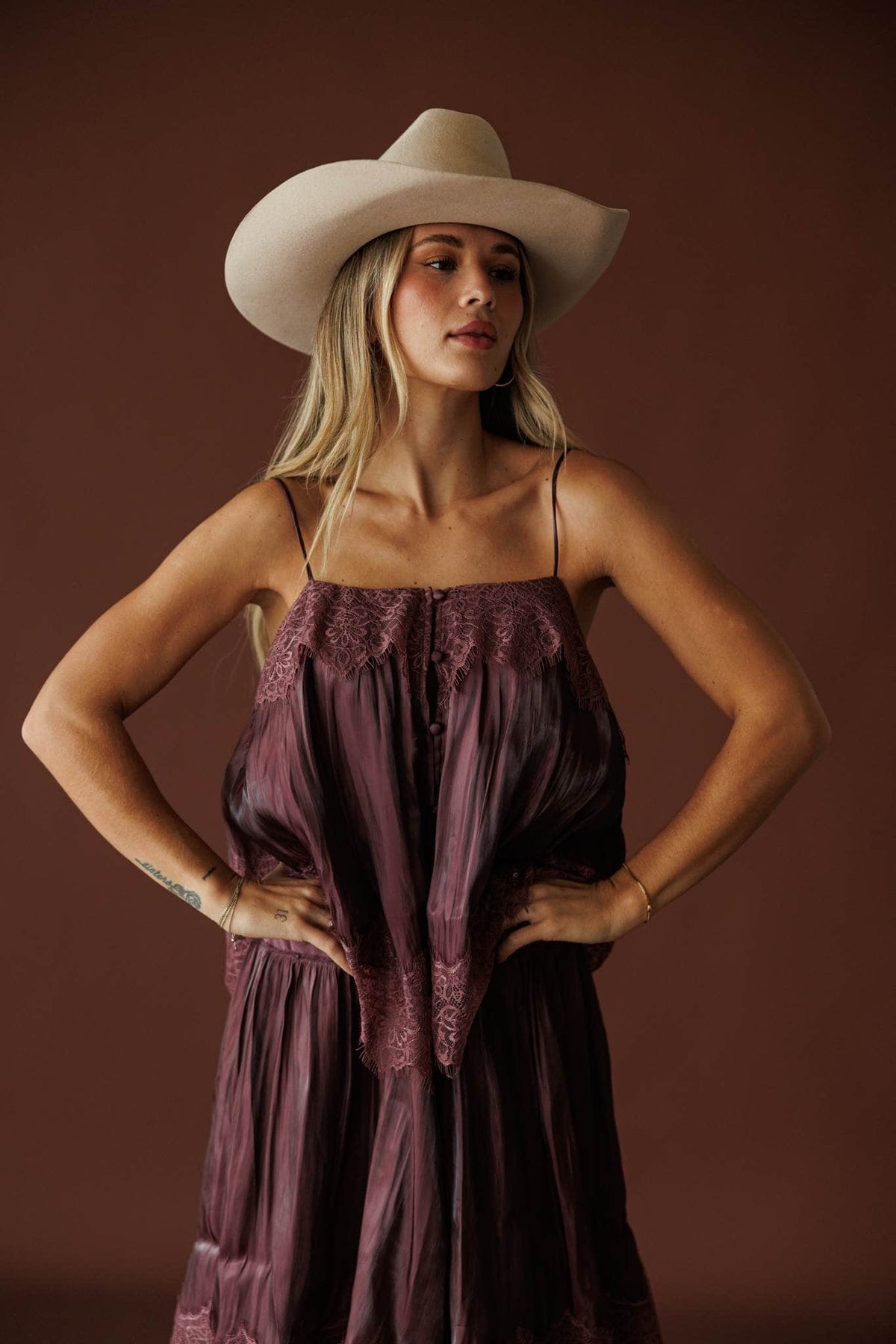 Where The Wildflowers Grow Maxi Dress in plum, front view of the smocked bodice with a cowboy hat