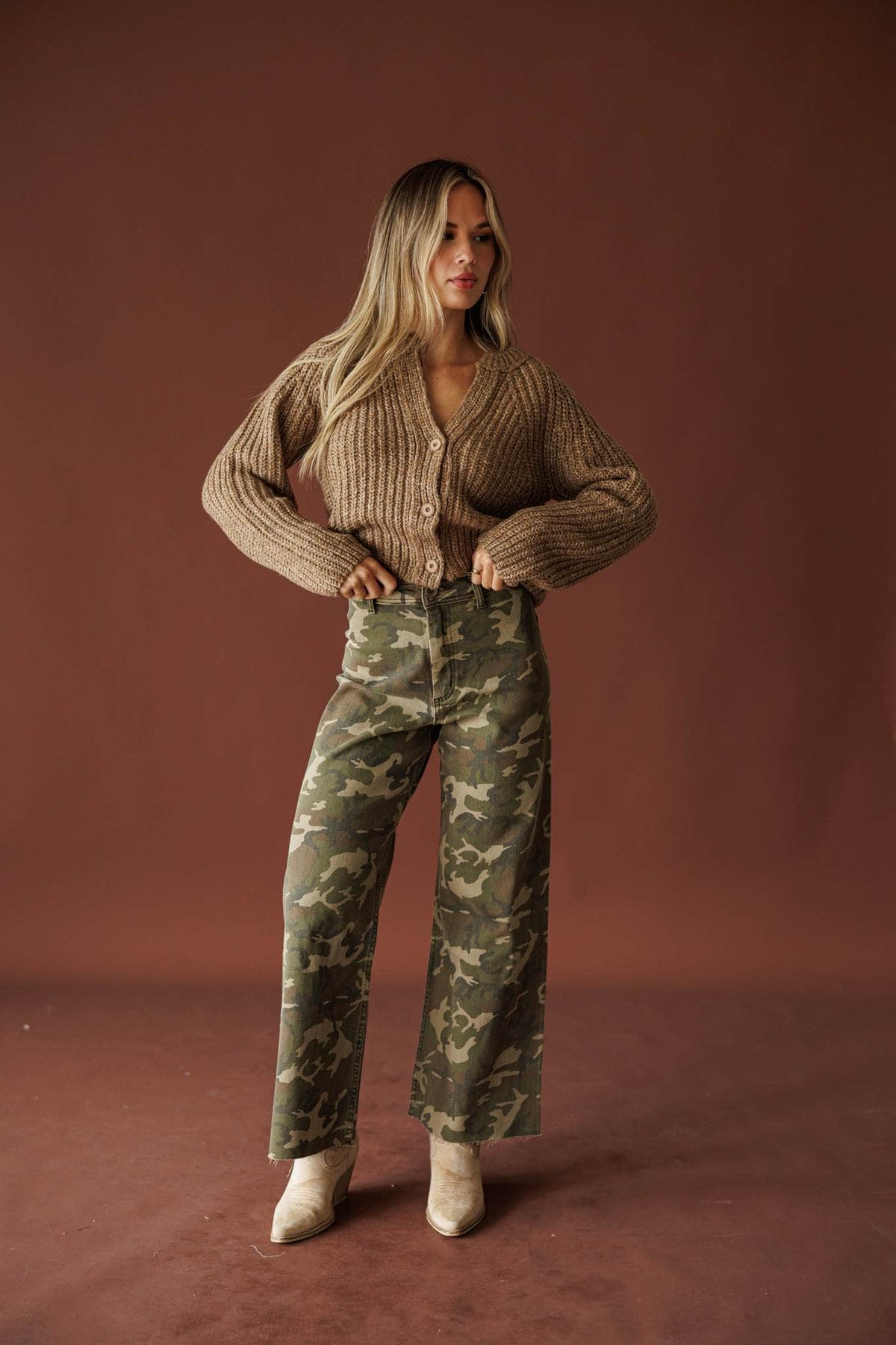 Urban Camo Pants, in camouflage, full-length front view with a tan cardigan