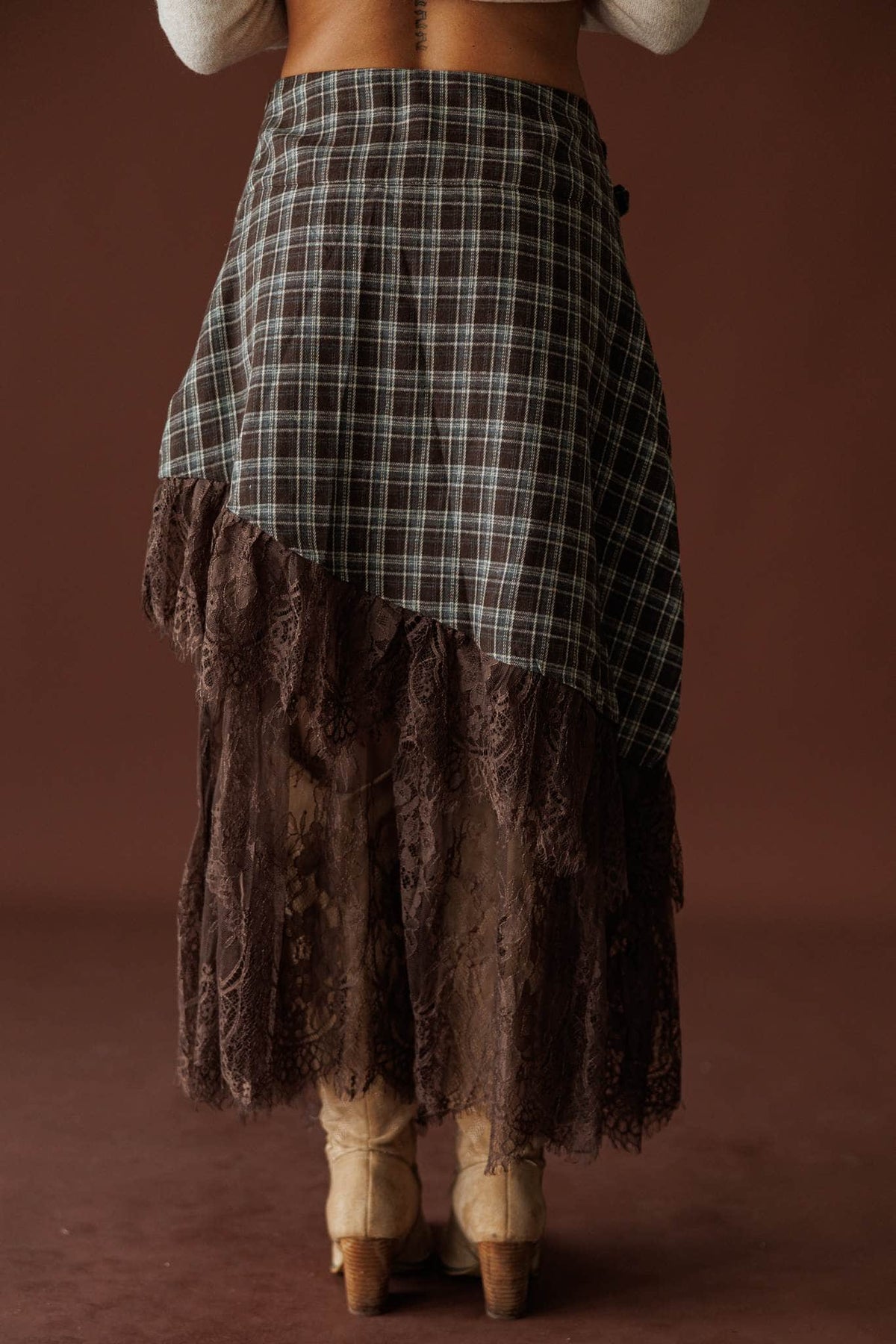 Lost In Wyoming Plaid Skirt in brown, back view of the diagonal plaid and lace hem