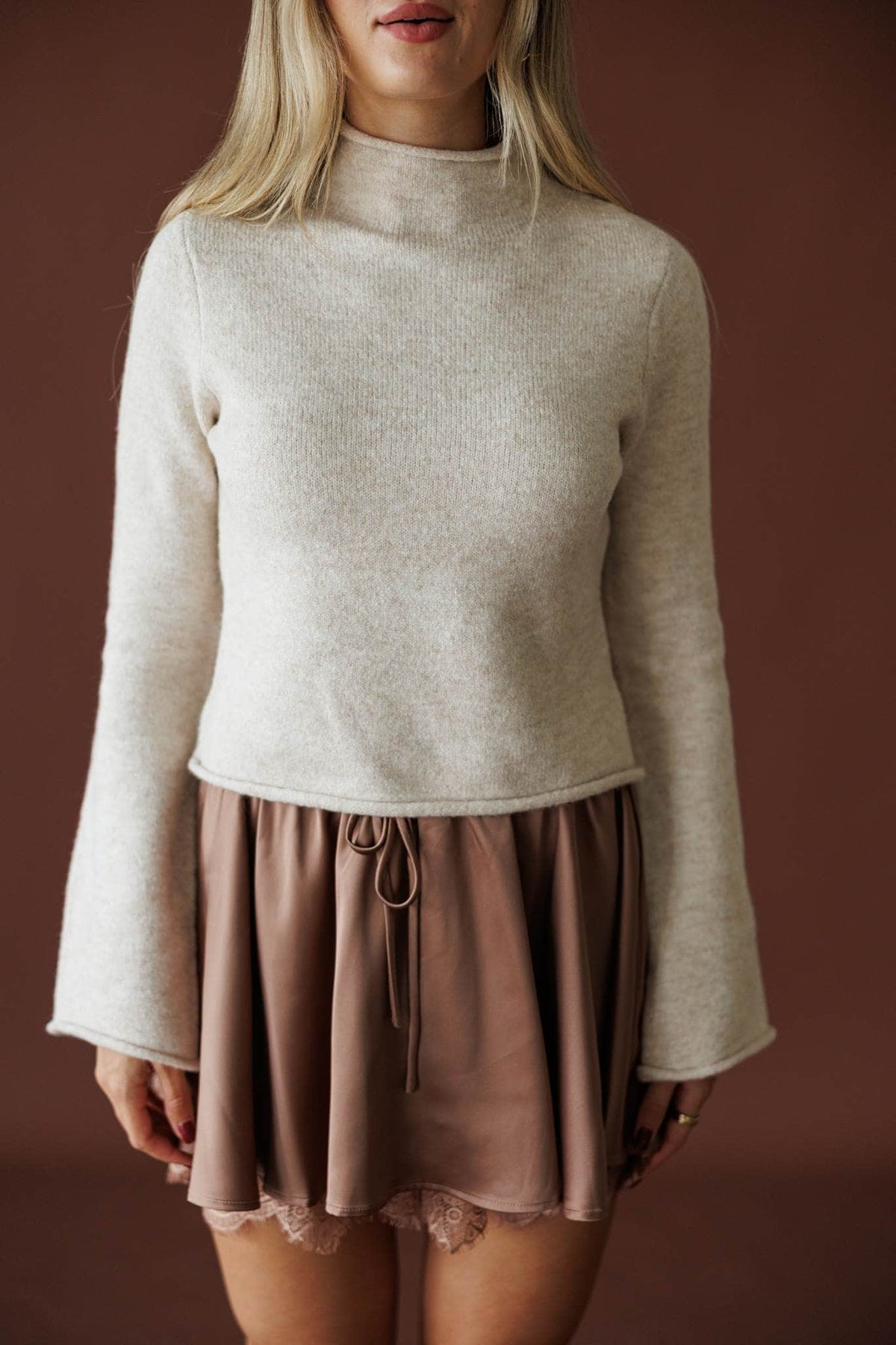 The Cozy Classic Sweater in oatmeal, front view showing the bell sleeves and brushed knit