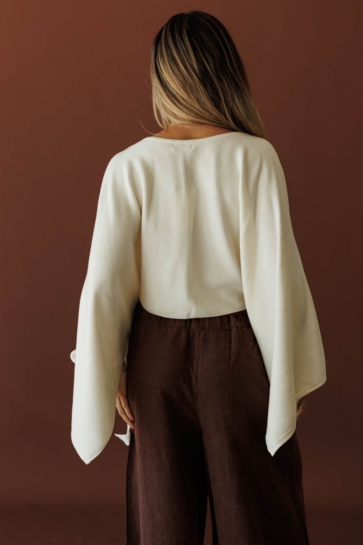 Wide Open Boat Neck Sweater, in cream, back view of the cropped body