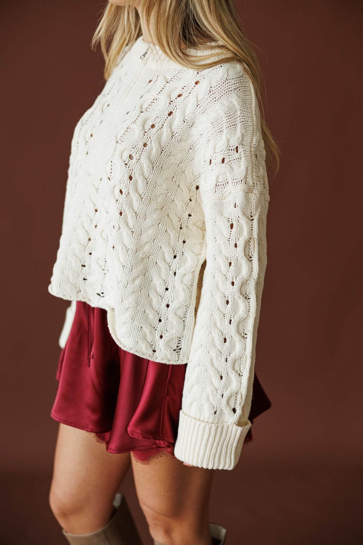 Cable Me Later Sweater in cream, three-quarter back view with the balloon sleeve extended